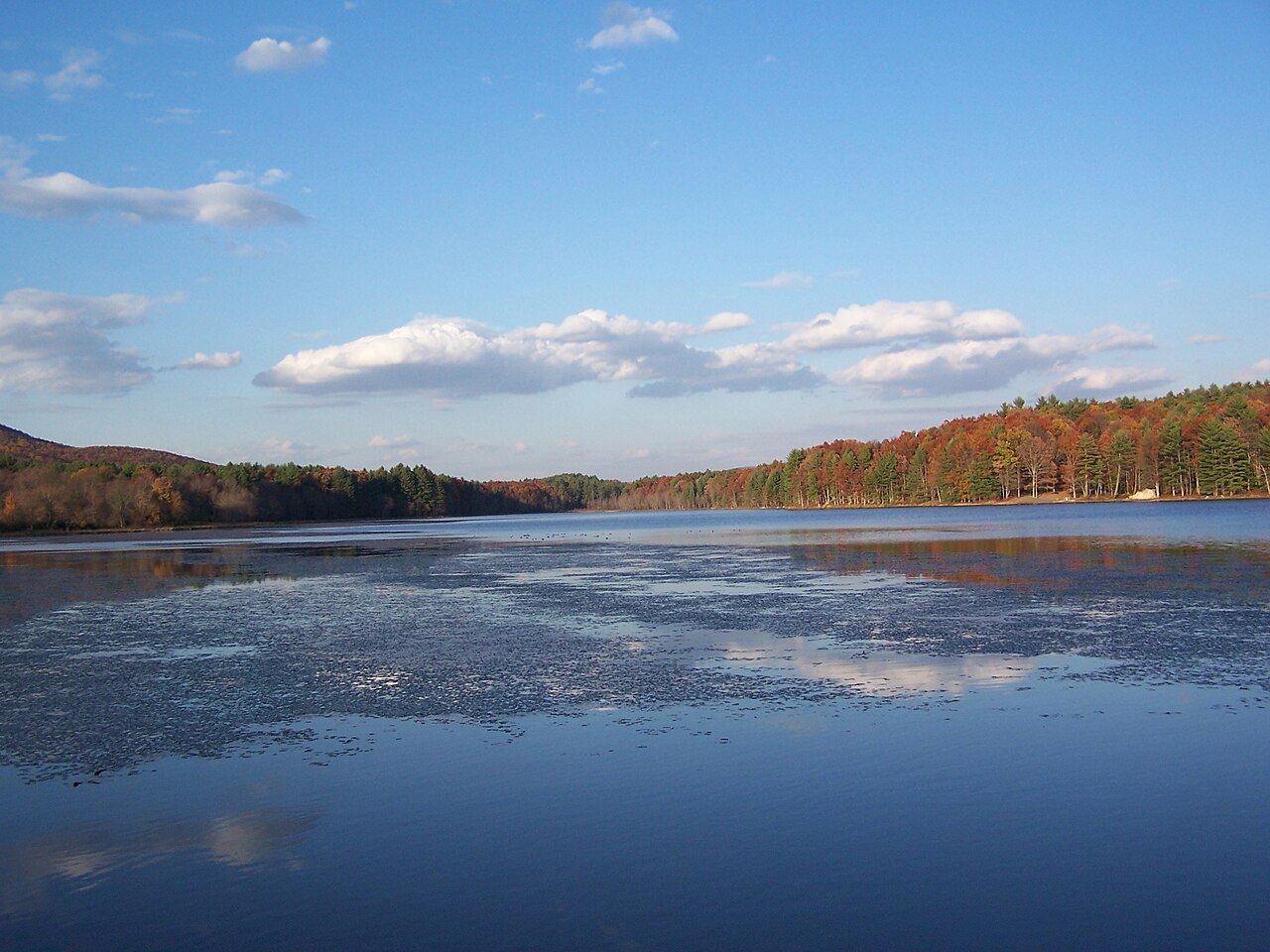Moncove Lake surrounded by wooded hills in autumn, photographed in November 2007